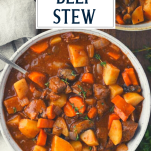 Overhead shot of a bowl of dutch oven beef stew with text title overlay