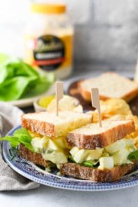 The best egg salad sandwich recipe served on a blue and white plate