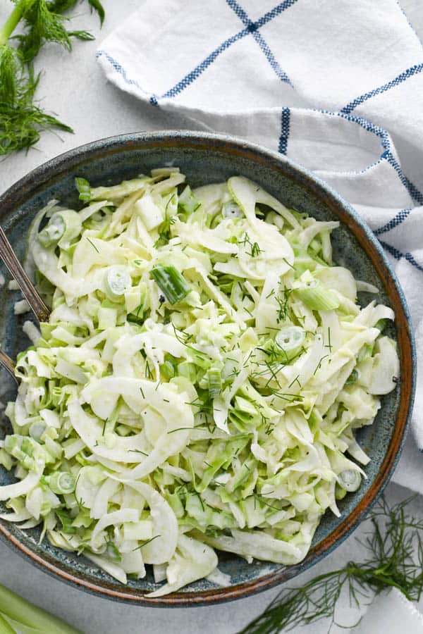 Overhead shot of fennel slaw in a blue bowl