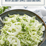 Bowl of shaved fennel salad with apples and text title overlay
