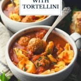 Spoon in a bowl of meatball soup with cheese tortellini and text title overlay