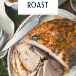 Overhead shot of pork sirloin roast sliced with text title overlay at top
