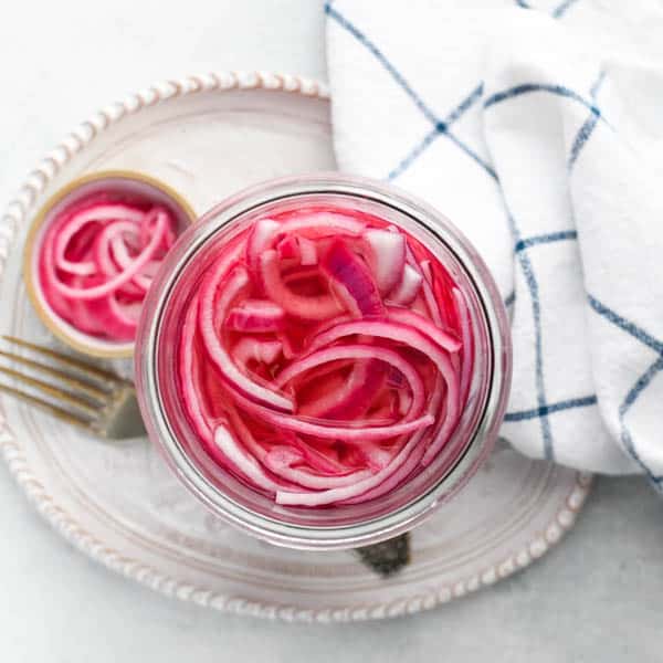 Overhead image of easy pickled red onions in a glass jar