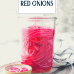 Front shot of a jar of quick pickled red onions with text title overlay