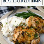 The best crispy baked chicken thighs on a plate with text title box at the top