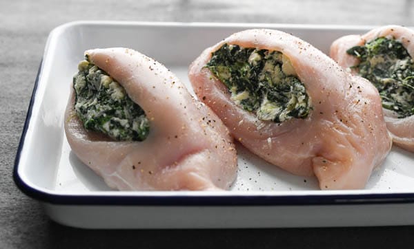 Process shot showing how to make stuffed chicken breast with spinach
