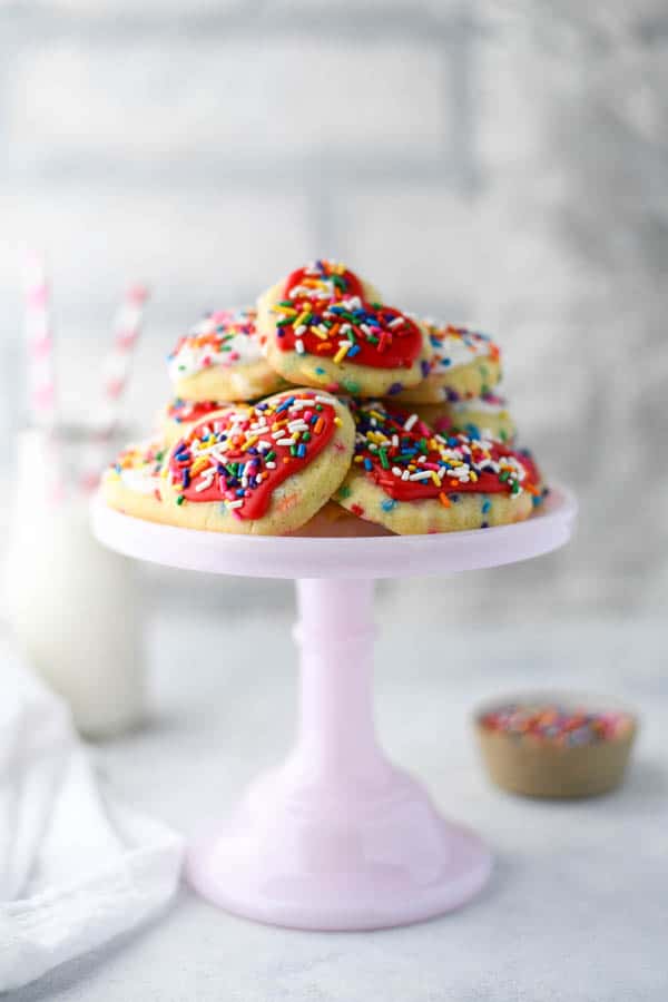 Front shot of the best sprinkle cookie recipe served on a pink cake stand