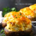 Side shot of a twice baked potatoes on a serving platter