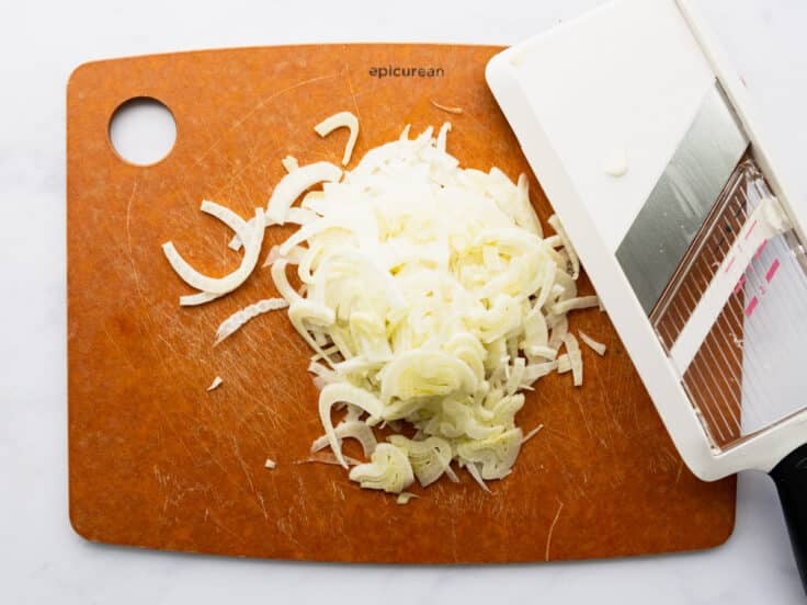 Shaving fennel with a mandoline.