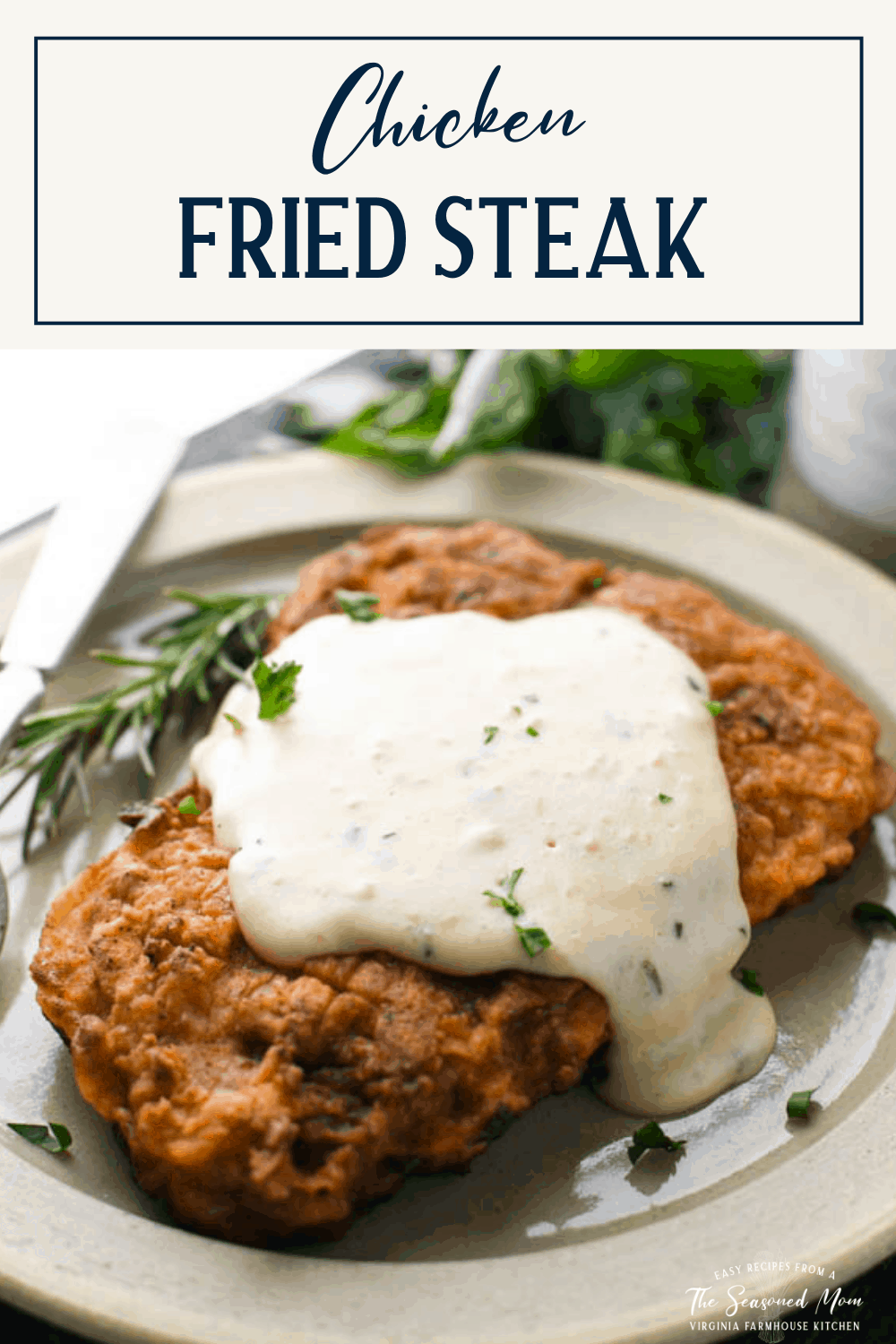 Easy chicken fried steak on a plate with gravy and fresh herbs and text title box at top
