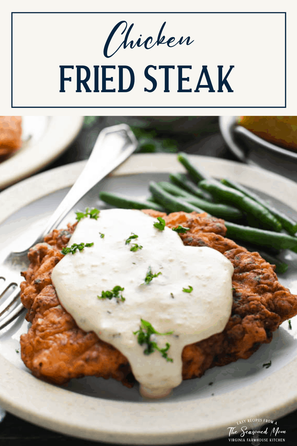 The best chicken fried steak recipe on a plate with text title box at top