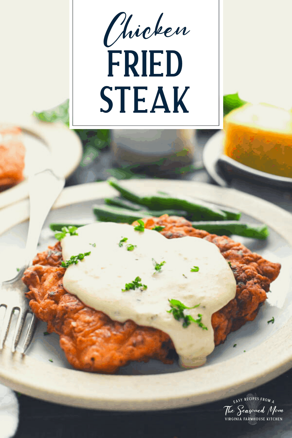 Chicken fried steak on a plate with green beans and text title overlay