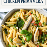Close overhead shot of creamy chicken primavera in a bowl with text title box over top