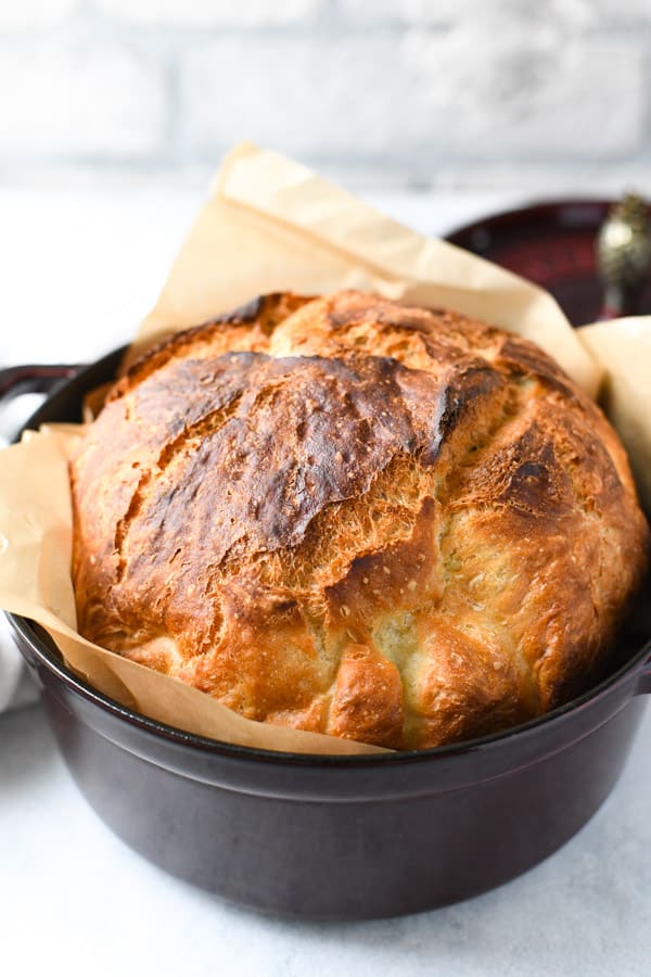 Dutch oven bread in front of a white brick wall
