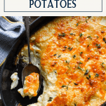 Overhead image of cheesy and creamy au gratin potatoes in a dish with text title box at top