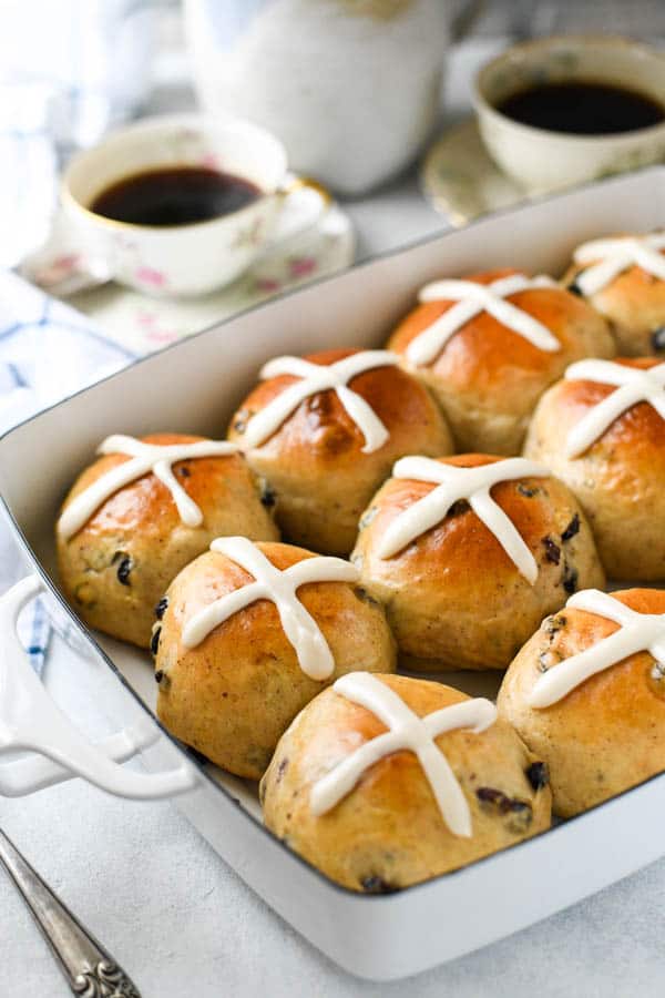 Close up side shot of easy hot cross buns recipe baked in a white dish