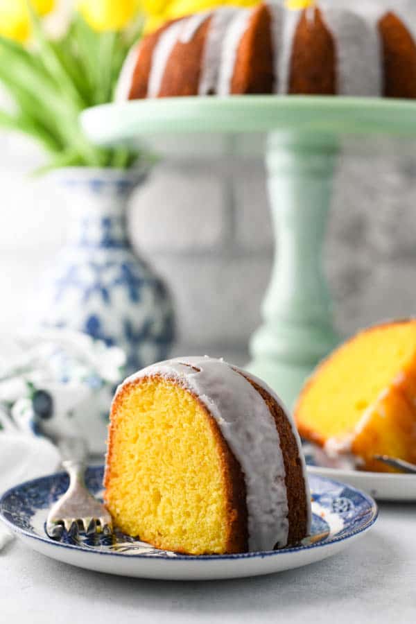 An easy Lemon Bundt Cake recipe with lemon glazed served on a blue and white plate