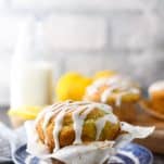 Front shot of lemon and poppy seed muffins on a blue and white plate with glaze
