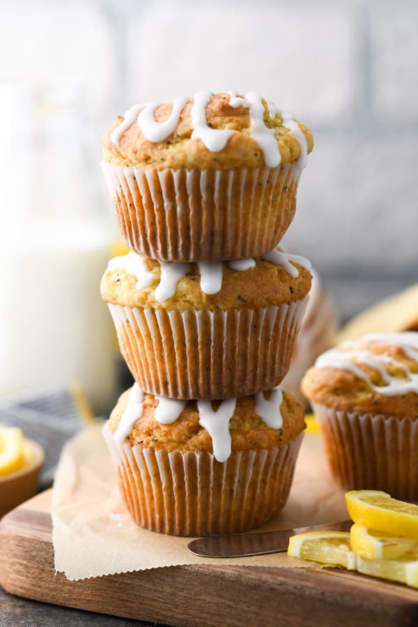 Three easy lemon poppy seed muffins stacked on top of each other