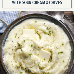 Overhead image of a bowl of mashed potatoes with sour cream and chives and a text title box at top