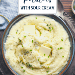 Overhead shot of a bowl of sour cream mashed potatoes with text title overlay