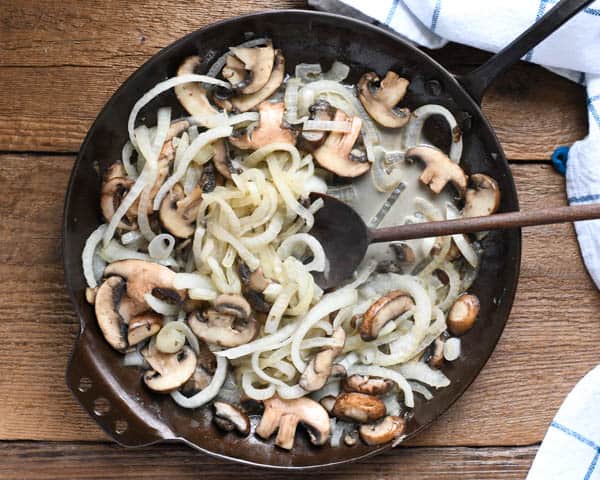 Sauteed mushrooms and onions in a skillet