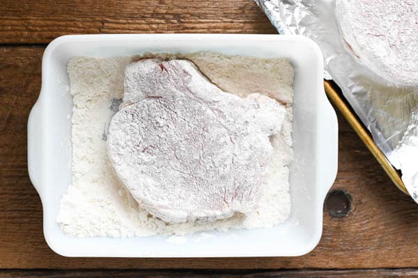 Dredging pork chops in flour
