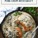 Overhead shot of smothered pork chops in a cast iron skillet with text title box at top