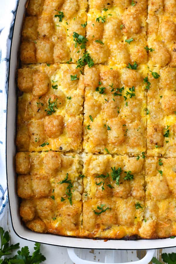 Close overhead shot of the best tater tot breakfast casserole in a white dish