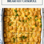 Overhead image of a tater tot breakfast casserole with text title box at top