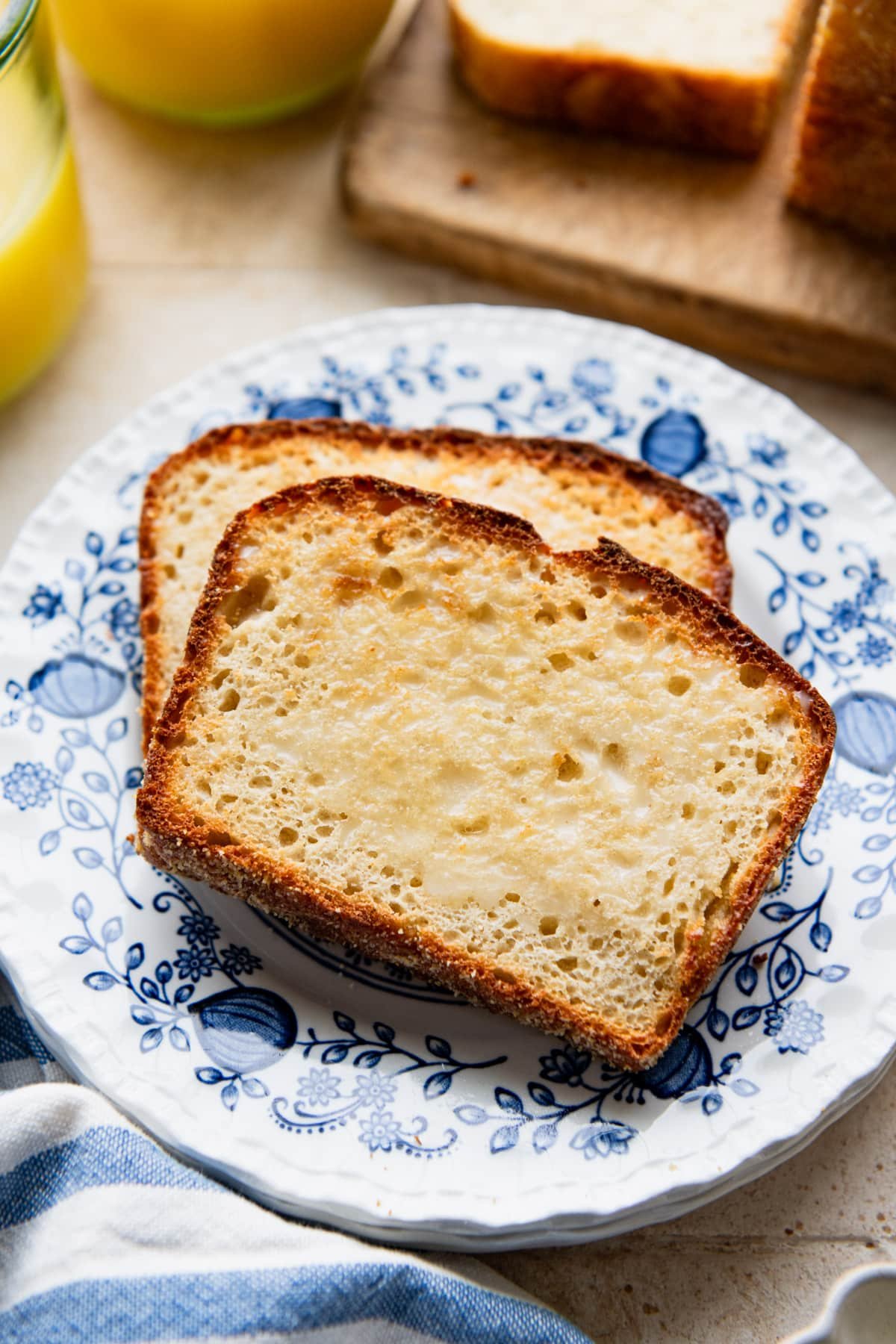 Side shot of toasted English muffin bread slices on a plate.