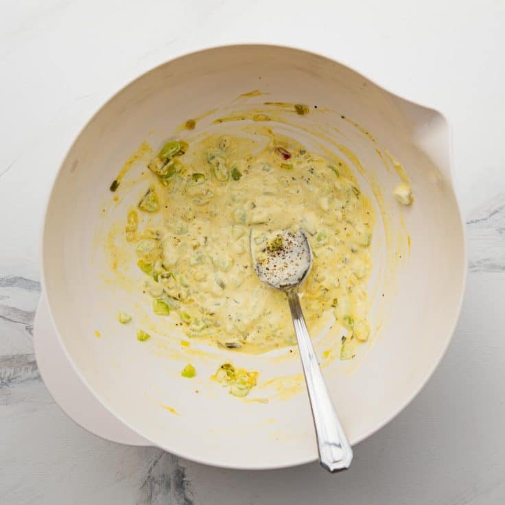 Stirring together the dressing for egg salad.