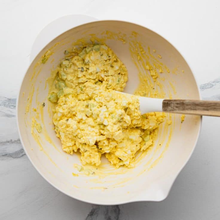 Process shot showing how to make an old fashioned egg salad sandwich recipe.