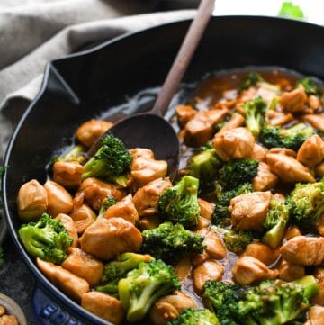 Close up side shot of Chinese Chicken Broccoli Stir Fry in a cast iron skillet