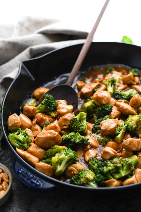 Close up side shot of Chinese Chicken Broccoli Stir Fry in a cast iron skillet