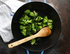 Process shot showing how to make Chinese chicken broccoli stir fry in a wok