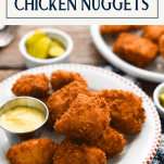 Side shot of a plate of fried chicken nuggets with text title box at top
