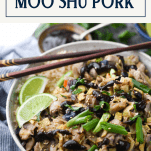 Close up shot of a bowl of moo shu pork with rice and text title box at top