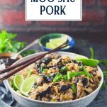 Side shot of a bowl of authentic moo shu pork with text title overlay