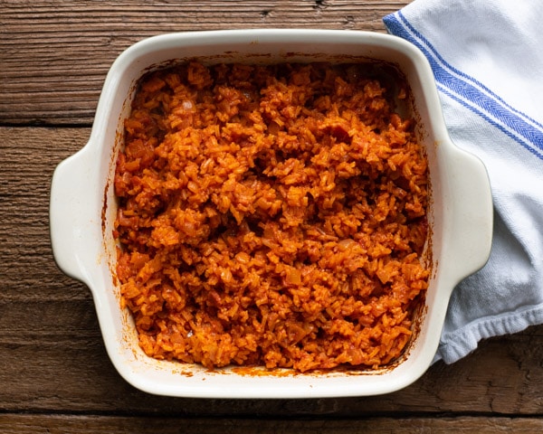 Overhead image of red rice baked in a casserole dish