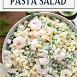Overhead shot of a bowl of shrimp pasta salad with peas and text title box at top