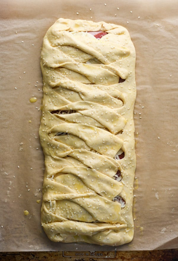 Process shot showing how to make a homemade Stromboli crescent braid