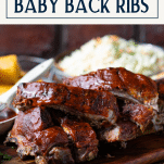 Side shot of baked baby back ribs in foil with text title box at top