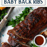 Overhead image of simple baby back ribs in oven with text title box at top