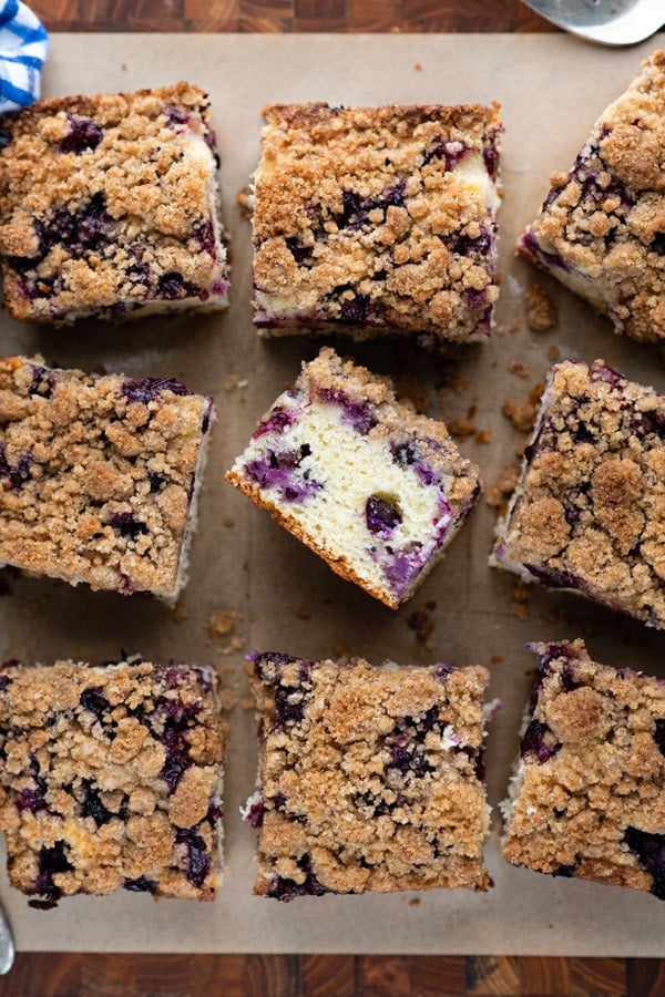 Overhead shot of old fashioned blueberry buckle recipe cut into bars on a wooden cutting board