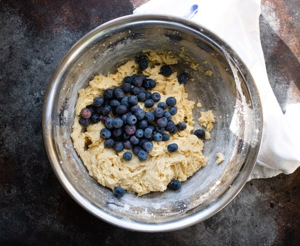 Ingredients for blueberry buckle in a metal mixing bowl