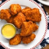 Square overhead shot of a plate of the best chicken nuggets recipe.