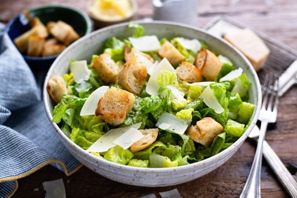 Horizontal side shot of a bowl of classic Caesar salad recipe