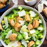 Homemade caesar salad served in a bowl on a wooden table