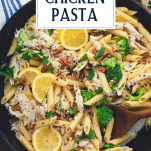 Creamy pesto chicken pasta in a skillet with text title overlay
